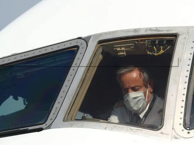 a pilot wearing a protective mask is seen in a cargo aircraft chartered by the un world food programme with medical supplies to help developing countries hit by the coronavirus disease covid 19 outbreak at liege airport belgium photo reuters file a pilot wearing a protective mask is seen in a cargo aircraft chartered by the un world food programme with medical supplies to help developing countries hit by the coronavirus disease covid 19 outbreak at liege airport belgium photo reuters file