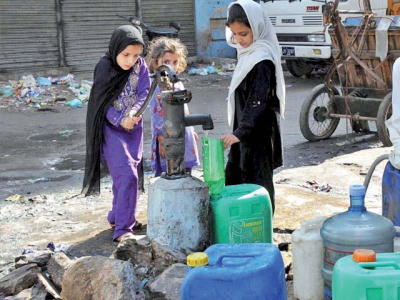 young girls fill water in cans from a hand pump the city s residents have long been struggling with water woes due to shortfalls leaky pipes and theft photo file