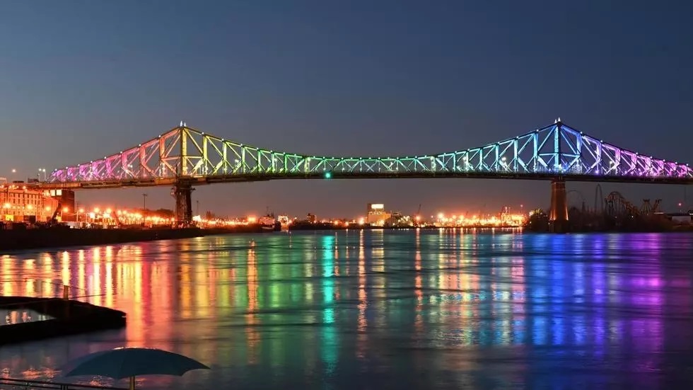 the jacques cartier bridge in montreal is lit up in the colors of the rainbow on april 11 2020 as a sign of hope and a symbol of solidarity with victims of the coronavirus photo afp