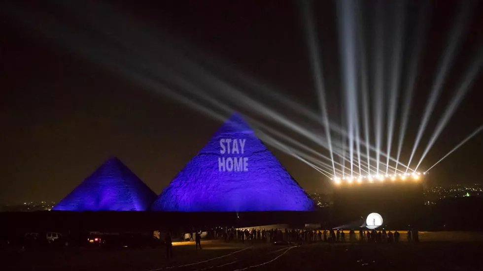 the great pyramids are lit up with a coronavirus themed laser projection that says quot stay home quot photo afp