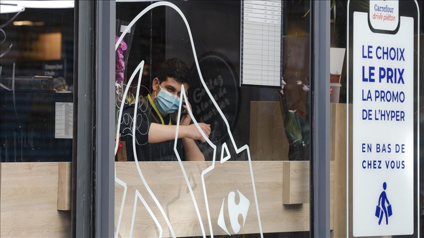 a supermaket employee wears a medical mask within precautions against coronavirus as he speaks on the phone in a supermarket in paris france photo aa