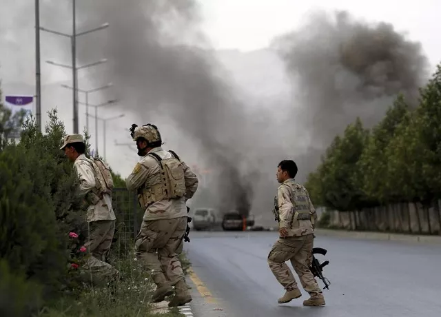 members of afghan security forces cross a road as smoke billows from the site of an attack near the afghan parliament in kabul photo reuters members of afghan security forces cross a road as smoke billows from the site of an attack near the afghan parliament in kabul photo reuters