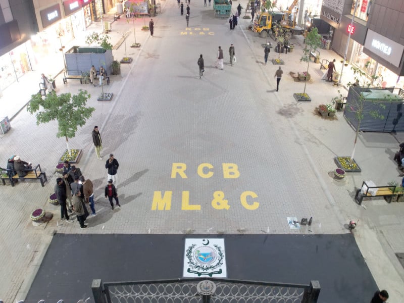 pedestrians stroll along rawalpindi s first underground cabling based walking street featuring heavy gates at each block entrance and exit while canning and kashmir roads remain open for traffic photo express