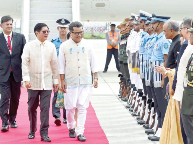philippines president ferdinand marcos 2l walks alongside india s minister of state for external affairs pabitra margherita c as he inspects the honour guard upon his arrival at the airport in new delhi photo afp