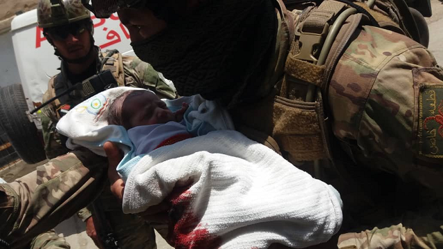 security forces rescuing a newborn baby from hospital under attack in kabul photo tolo news