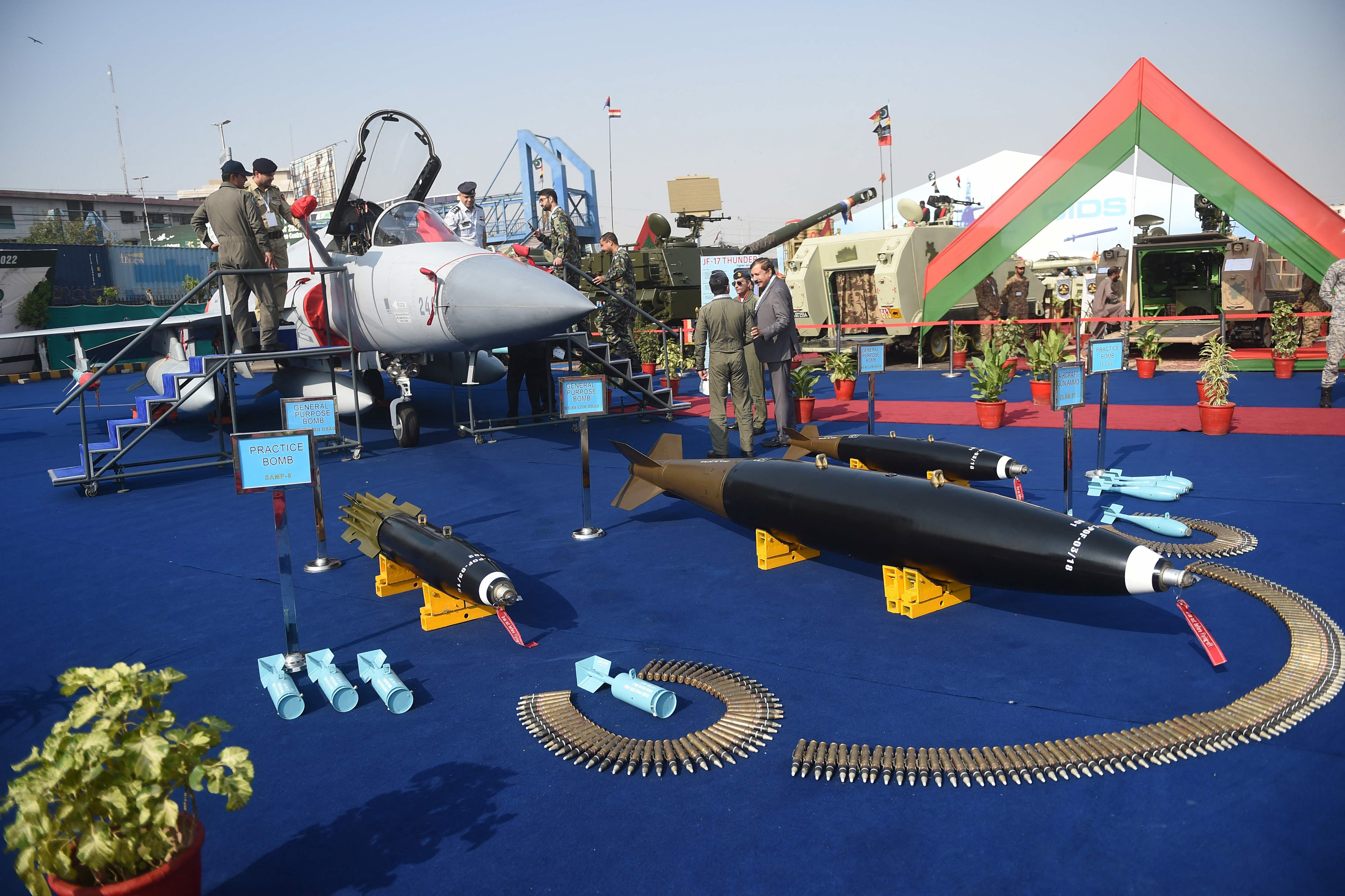 military officials gather around a jf 17 thunder aircraft and ammunition at the expo centre in karachi photo afp
