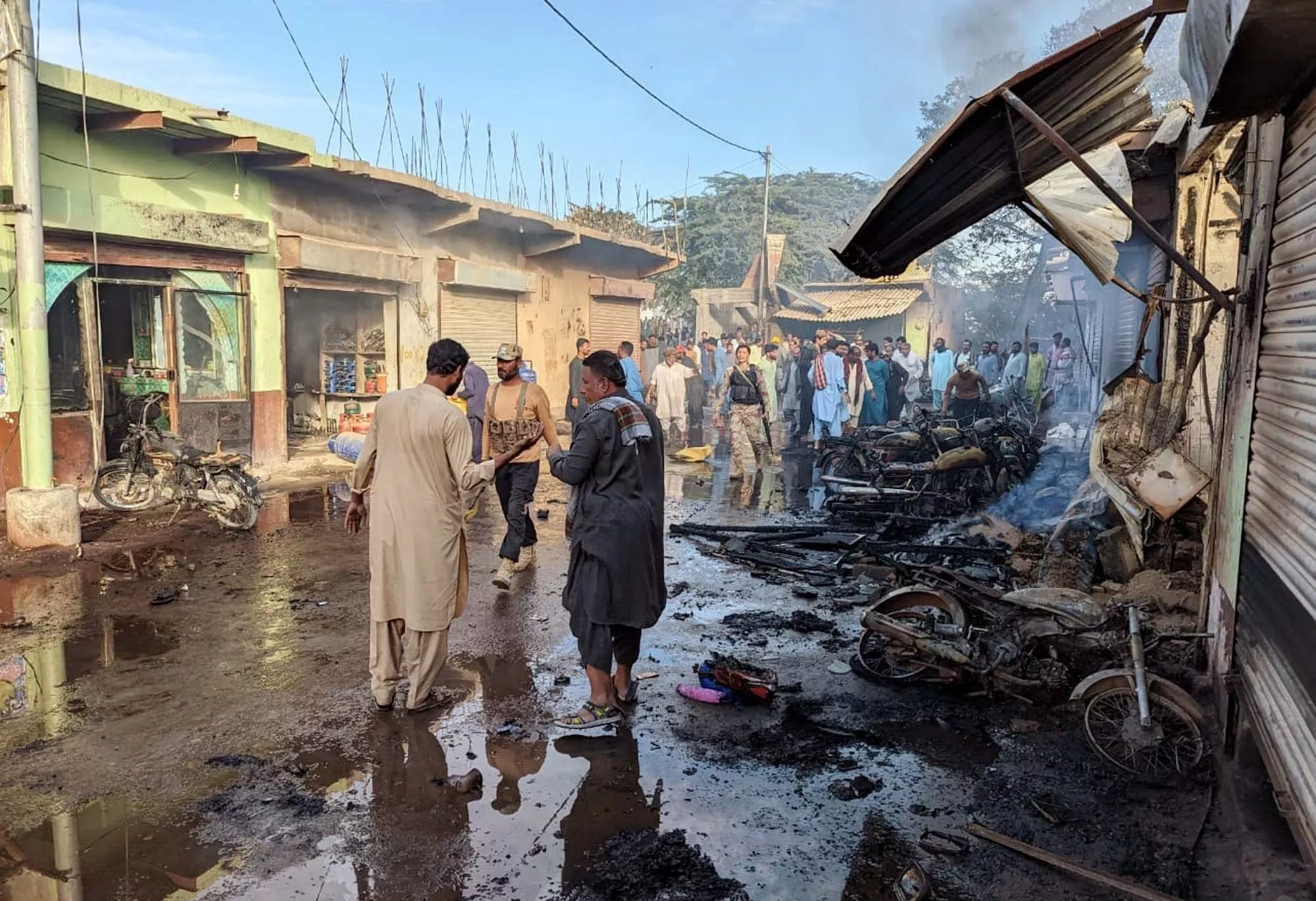 security officials and locals gather outside a gas filling shop at a market in lasbela where a powerful explosion took place photo ppi security officials and locals gather outside a gas filling shop at a market in lasbela where a powerful explosion took place photo ppi