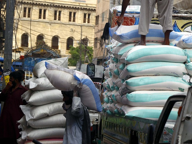 flour bags are being unloaded in karachi s jodia bazaar photo ppi