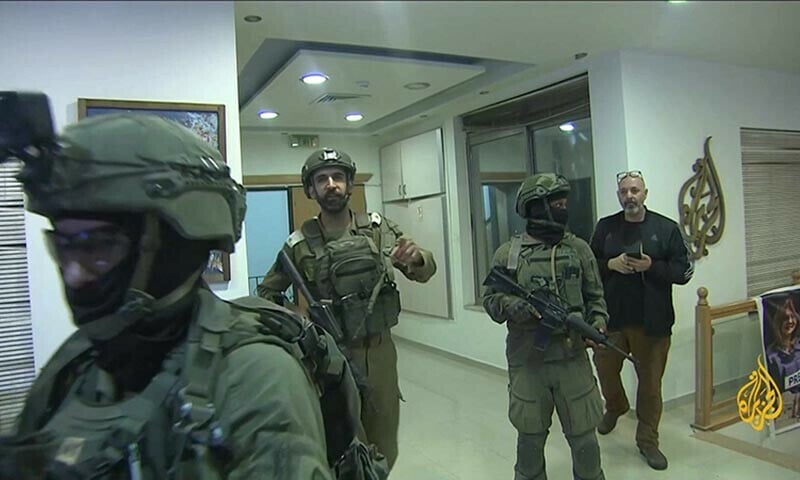 an image grab from footage distributed by al jazeera on september 22 shows israeli soldiers entering the channel s office in ramallah to issue a 45 day closure order photo afp