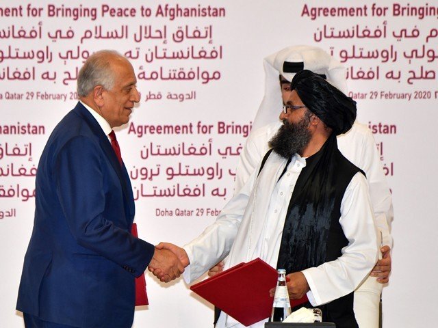 us special representative for afghanistan reconciliation zalmay khalilzad left and taliban co founder mullah abdul ghani baradar shake hands after signing a peace agreement during a ceremony in the qatari capital doha on february 29 2020 photo afp