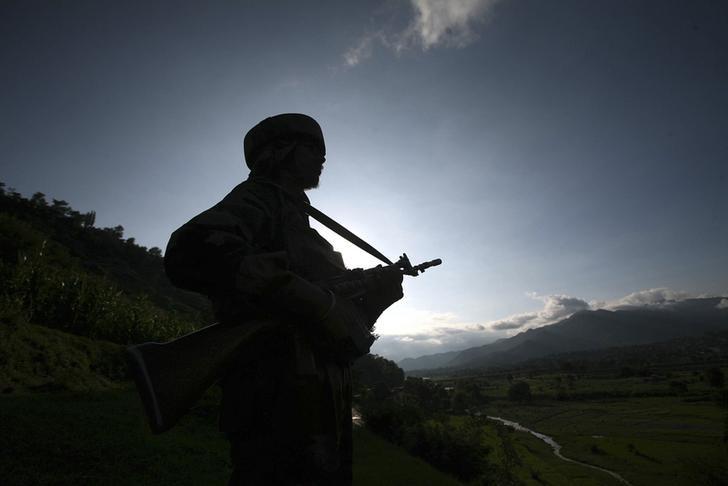 an indian army soldier stands guard while patrolling near the line of control photo reuters file