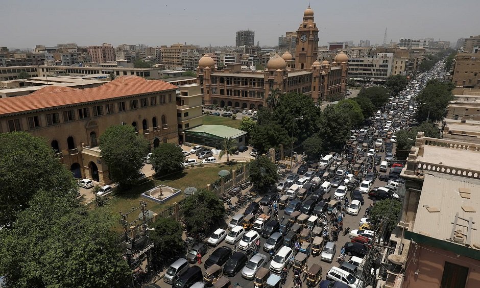 a general view of a road traffic and the karachi metropolitan corporation kmc building in the background after pakistan started easing the lockdown as the coronavirus disease covid 19 continues in karachi may 11 2020 reuters