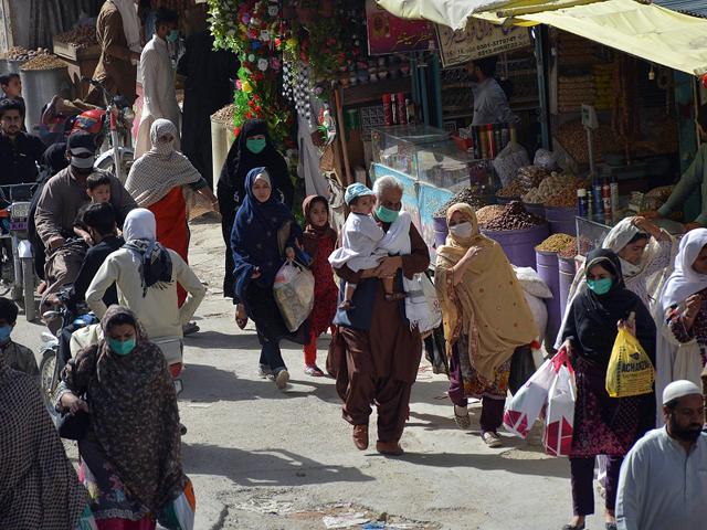 people walk in a market for shopping after the government eased a nationwide lockdown imposed as a preventive measure against the covid 19 in quetta on saturday photo afp