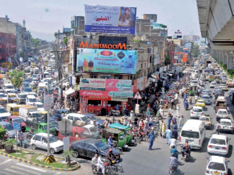 people are stuck in a traffic jam at a busy commercial in area due to lack of planning by the traffic police to handle the post lockdown eid shopping rush in rawalpindi photo nni
