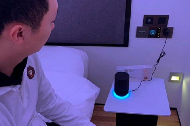 a staff member sits next to smart speaker tmall genie during a demonstration to the media inside a room of alibaba group 039 s futuristic flyzoo hotel in hangzhou zhejiang province china january 22 2019 photo reuters a staff member sits next to smart speaker tmall genie during a demonstration to the media inside a room of alibaba group 039 s futuristic flyzoo hotel in hangzhou zhejiang province china january 22 2019 photo reuters