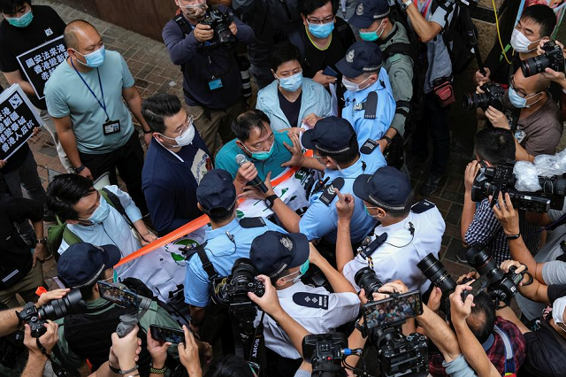 pro democracy lawmaker wu chi wai scuffles with police during a march against new security laws near china s liaison office in hong kong china may 22 2020 photo reuters