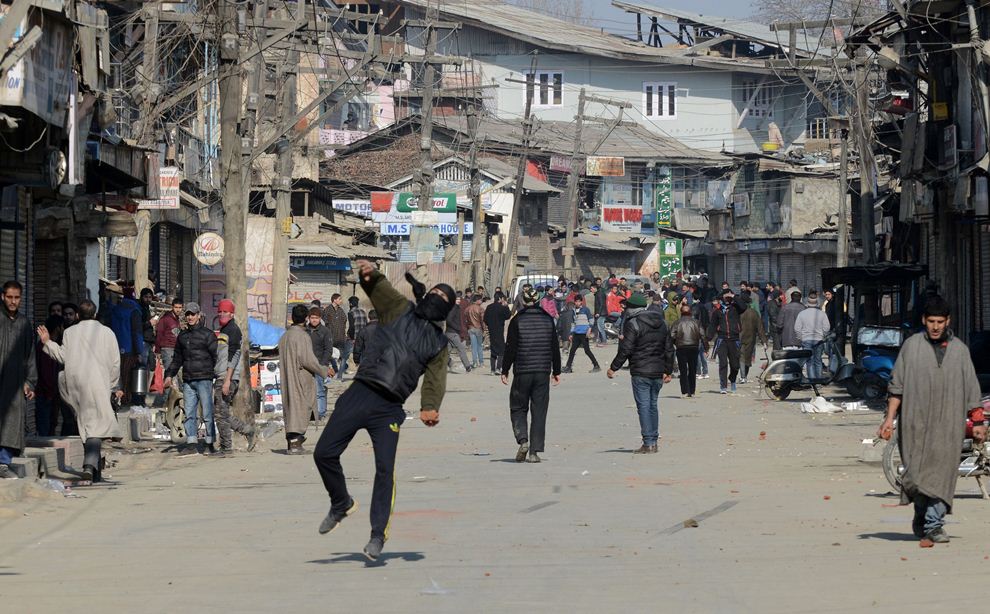 kashmiri supporters of the jammu and kashmir liberation front jklf throw stones towards indian police during a protest in srinagar on january 16 2015 jklf chairman mohammad yasin malik and supporters were demonstrating against a reported decision by the indian government to give permanent resident status to refugees of bangladesh formerly west pakistan who are settled in various areas of the winter capital of restive kashmir photo afp