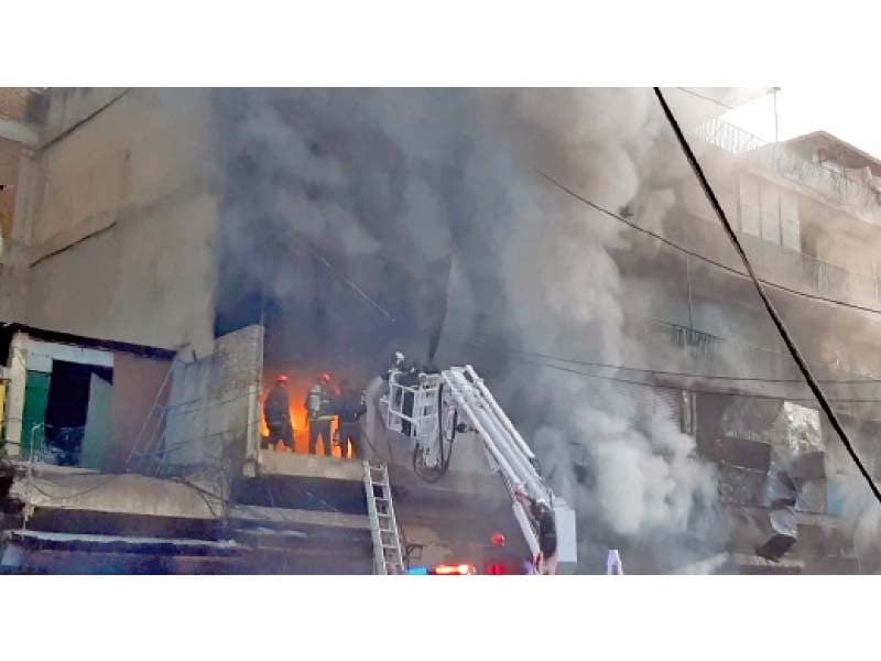 firefighters enter a building in raja bazaar to douse the flames photo express