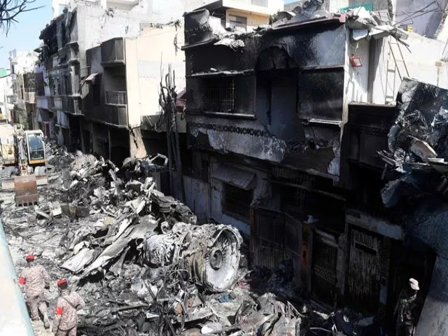 security personnel walk beside the wreckage of the crash pia plane photo afp security personnel walk beside the wreckage of the crash pia plane photo afp
