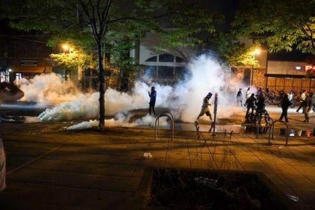 protesters run from tear gas near the minneapolis police third precinct where they gathered after a white police officer was caught on a bystander 039 s video pressing his knee into the neck of african american man george floyd who later died at a hospital in minneapolis minnesota us may 27 2020 reuters