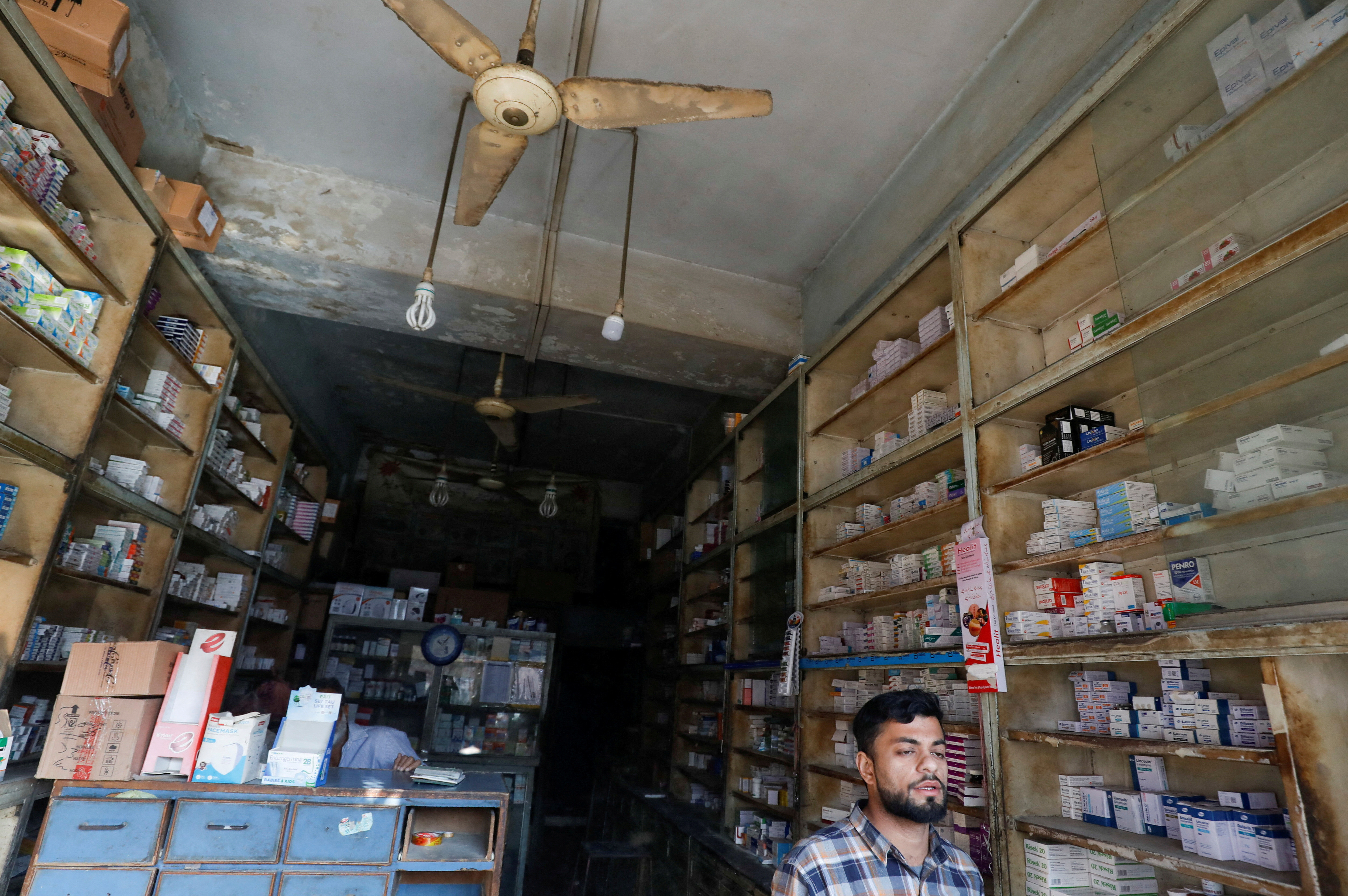 a man sells medicines at a medical store in karachi photo reuters