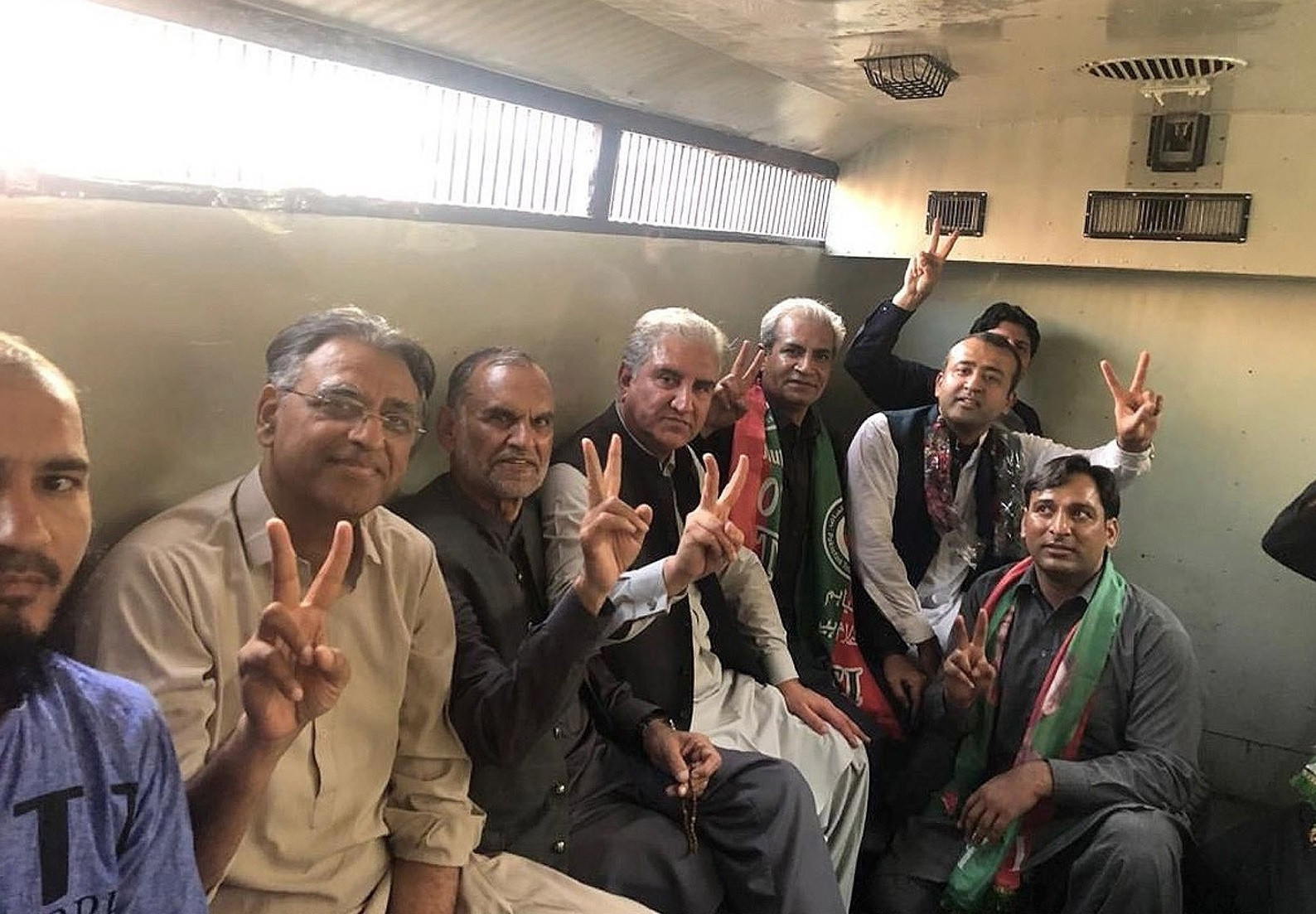pti leaders shah mahmood qureshi asad umar and others sit in a police van following their arrest in lahore photo nni
