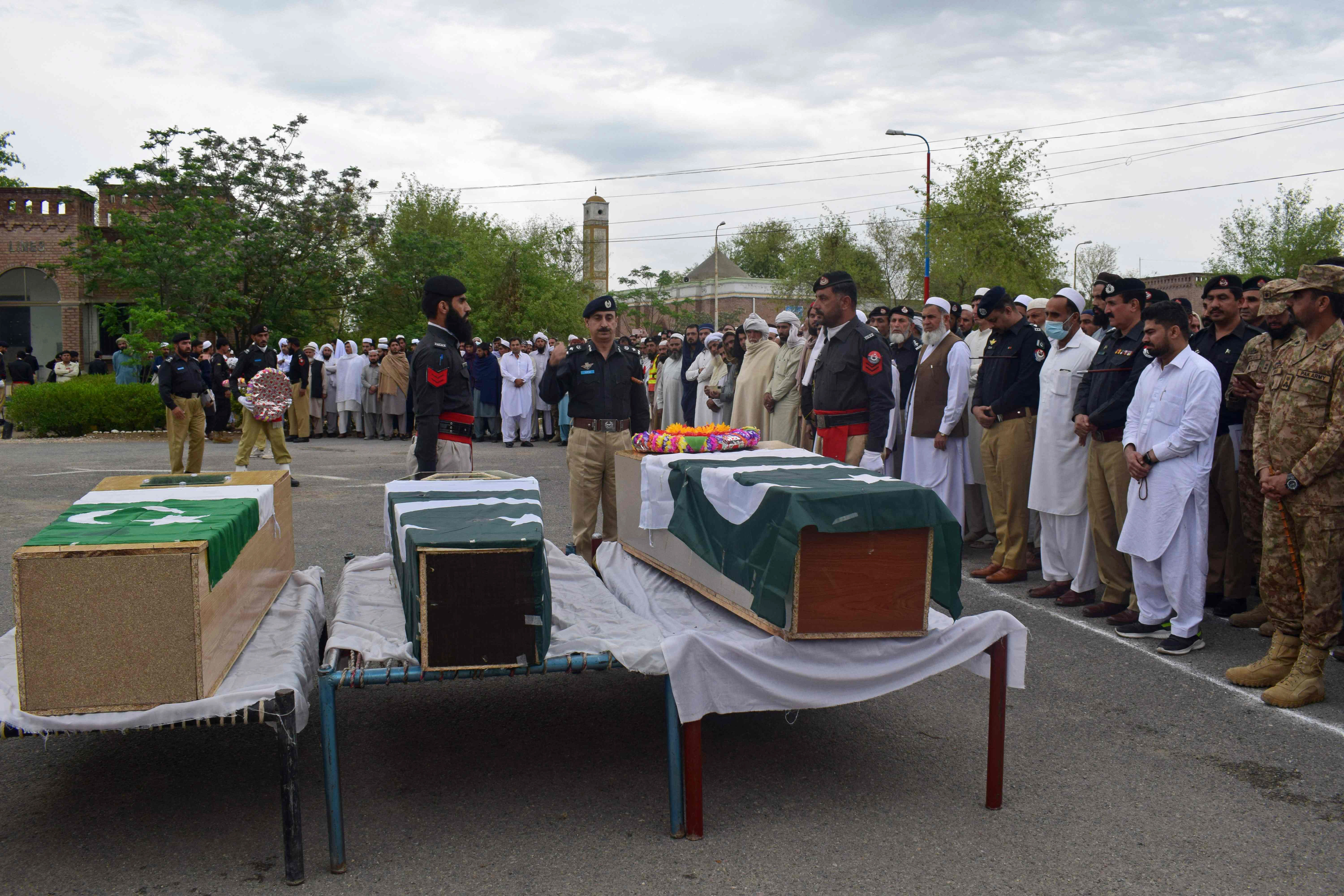 relatives and security officials prepare to offer funeral prayers for the martyred policemen in peshawar photo afp