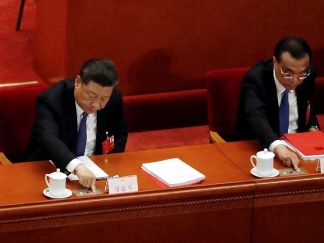 chinese president xi jinping and premier li keqiang cast their votes on the national security legislation for hong kong special administrative region at the closing session of the national people 039 s congress npc at the great hall of the people in beijing china photo reuters