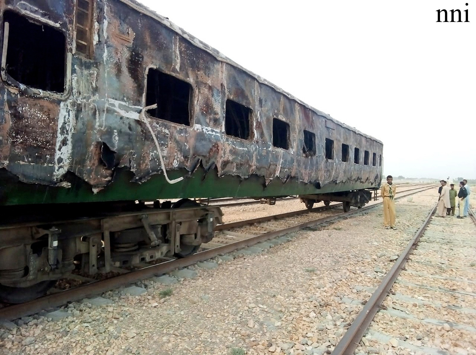 the charred remains of a karachi express coach stands on a rail track after an overnight fire near khairpur photo nni