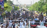 traders hold placards and banners as they stage a protest rally in rawalpindi against an unprecedented rise in the electricity bills photo online