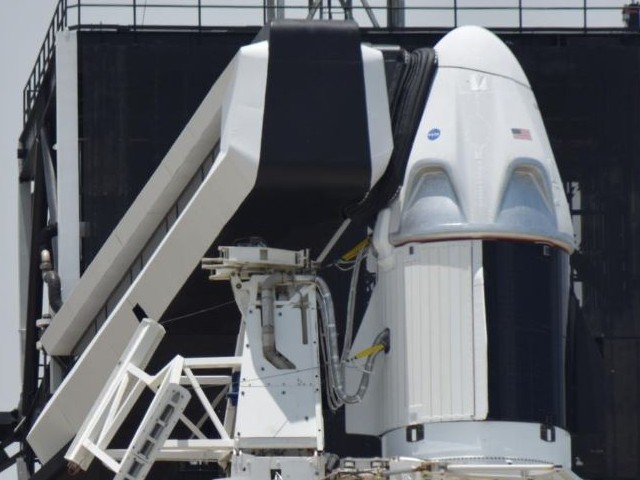 the spacex crew dragon spacecraft atop a falcon 9 booster rocket is connected to the crew access arm and launch tower on pad39a at the kennedy space centre in cape canaveral florida us photo reuters file