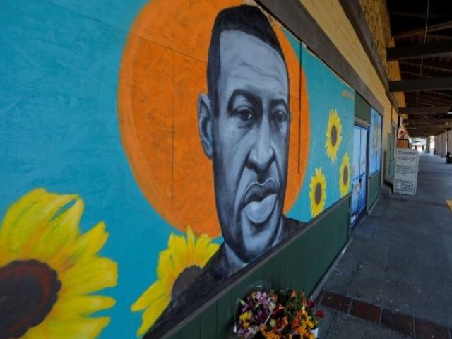 a portrait of george floyd is shown after residents painted the boarded up windows of shops following riots and looting may 30th in their small town of la mesa california photo reuters