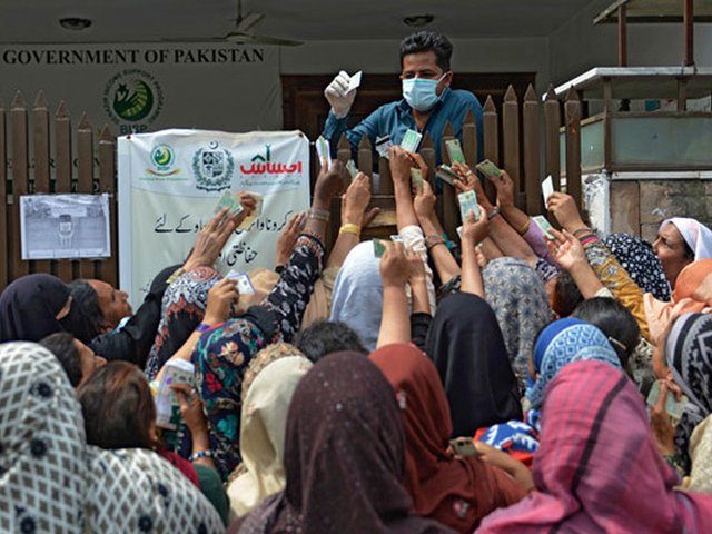 a government official checks cnics of ehsaas cash programme recipients photo afp file