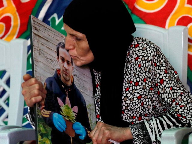 the mother of iyad hallak a 32 year old palestinian man with autism who was shot dead by israeli police when they mistakenly thought he was armed with a pistol mourns her son at their home in annexed east jerusalem photo afp