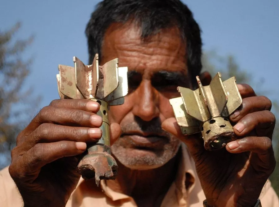 a man shows remains of an indian mortar shells photo afp file a man shows remains of an indian mortar shells photo afp file