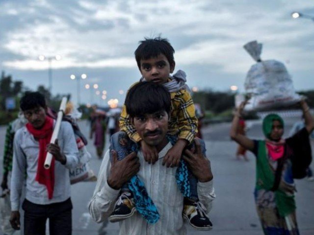 dayaram kushwaha a migrant worker carries his 5 year old son shivam on his shoulders as they walk along a road to return to their village during a 21 day nationwide lockdown to limit the spreading of coronavirus in new delhi india photo reuters file