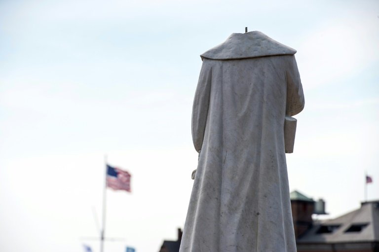 a decapitated statue of columbus is seen at christopher columbus park in boston massachusetts on june 10 photo afp