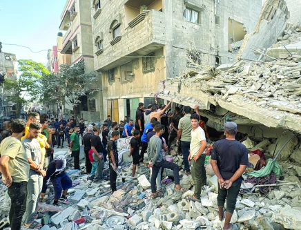 palestinians inspect the damage after an israeli air strike on a residential area in beit lahia the northern gaza strip photo afp