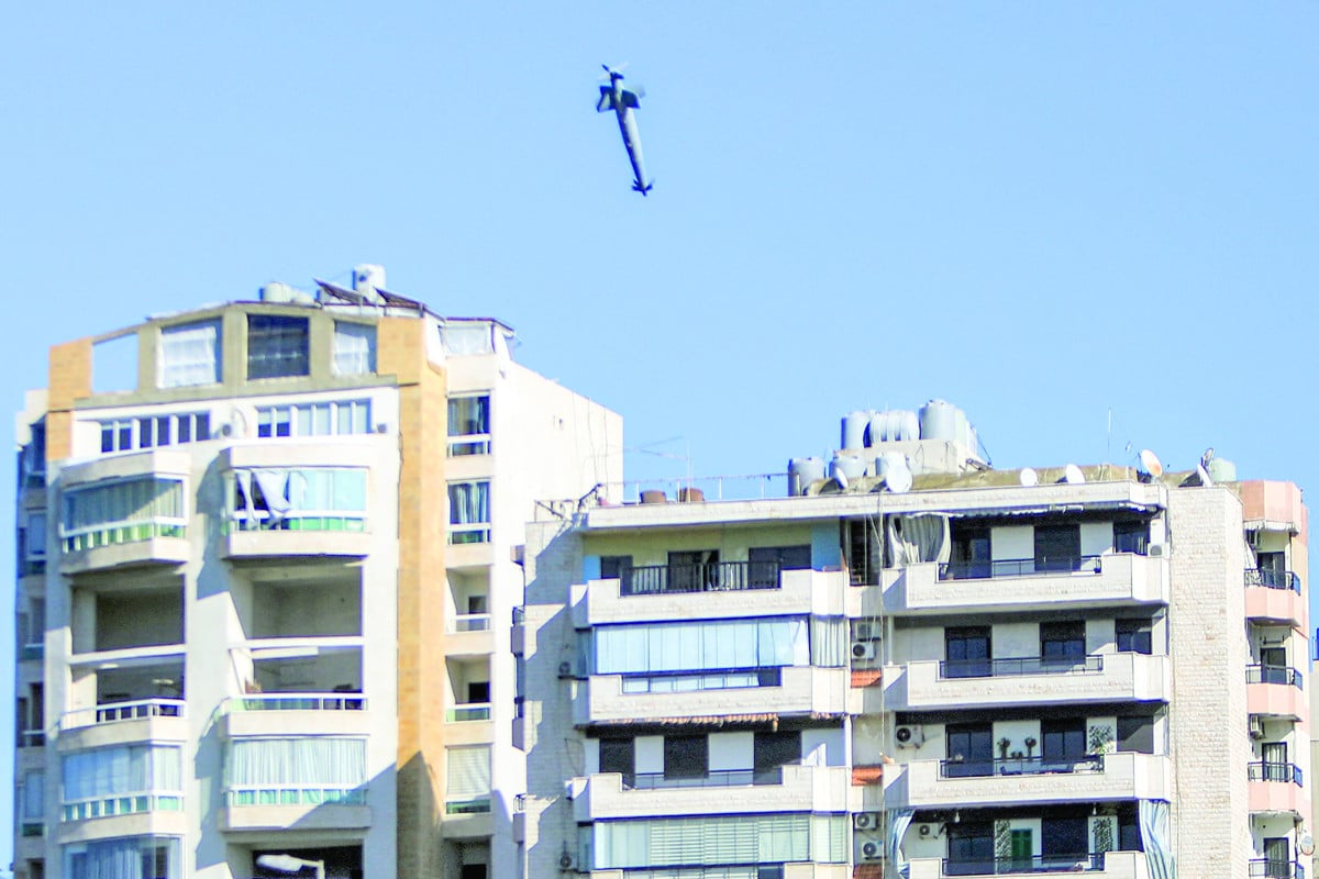 a rocket fired by an israeli war plane approaches a building in beirut s southern suburb of shayah photo afp