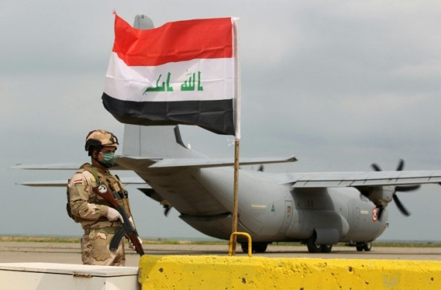 an iraqi soldier stands guard in front of a us military air carrier at the qayyarah air base near mosul in northern iraq on march 26 2020 the us says it will reduce troops in the country quot over coming months quot photo afp an iraqi soldier stands guard in front of a us military air carrier at the qayyarah air base near mosul in northern iraq on march 26 2020 the us says it will reduce troops in the country quot over coming months quot photo afp