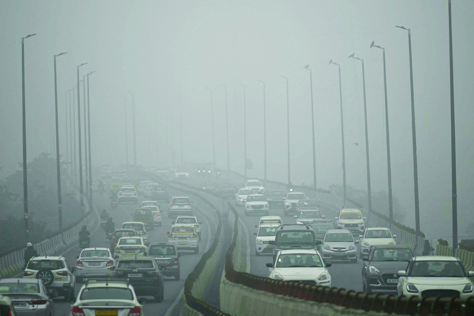 commuters drive amid dense smog in new delhi photo afp