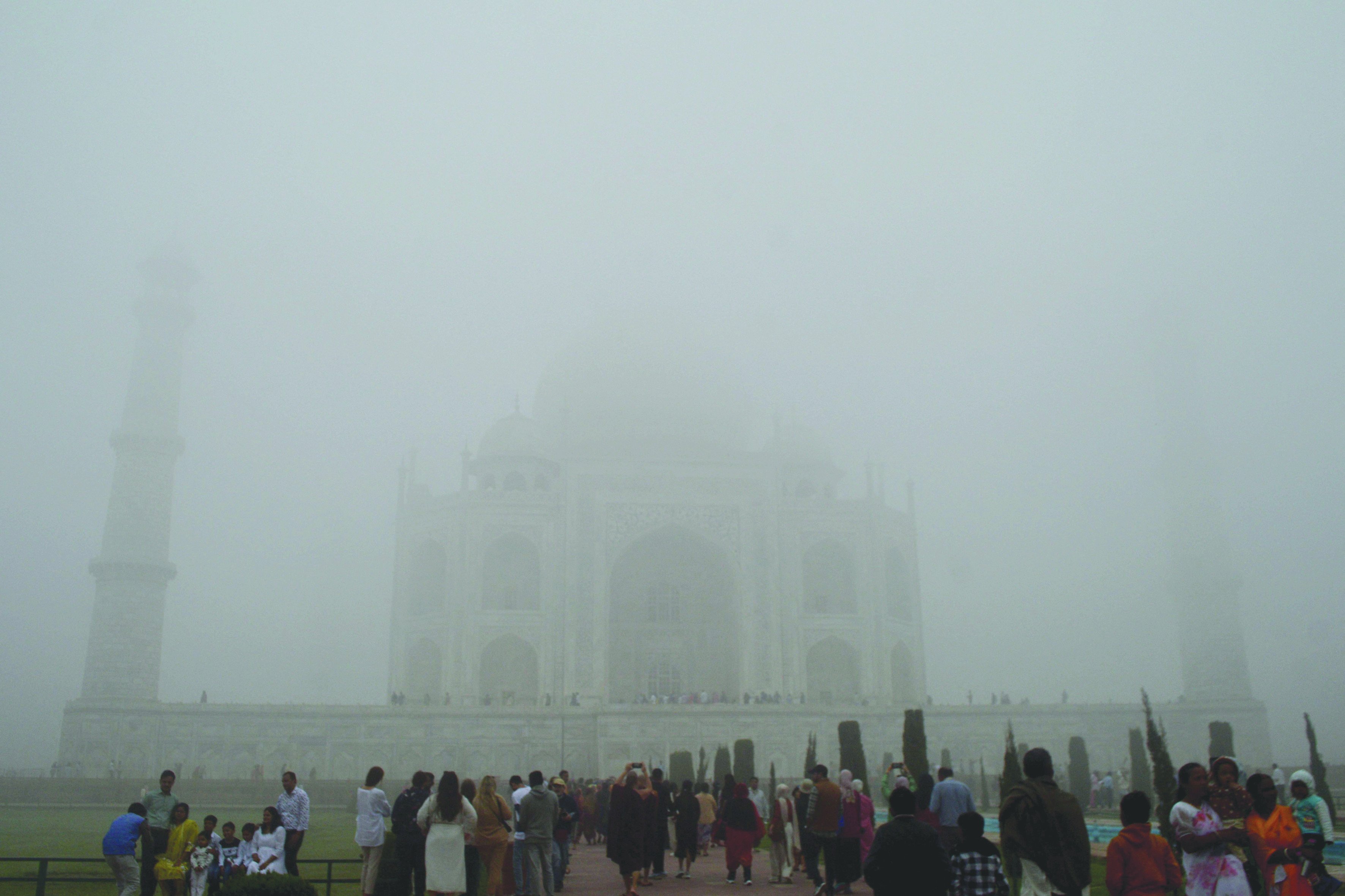 visitors look toward the taj mahal through morning air pollution and fog in agra photo reuters