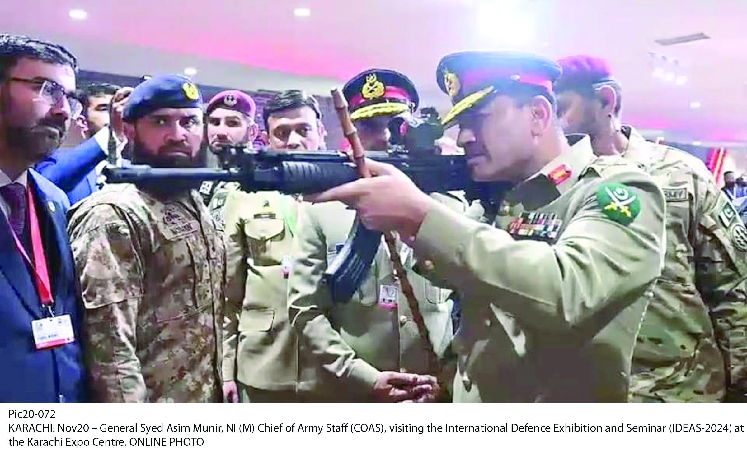 army chief gen syed asim munir inspects a rifle during a visit to ideas 2024 photo express