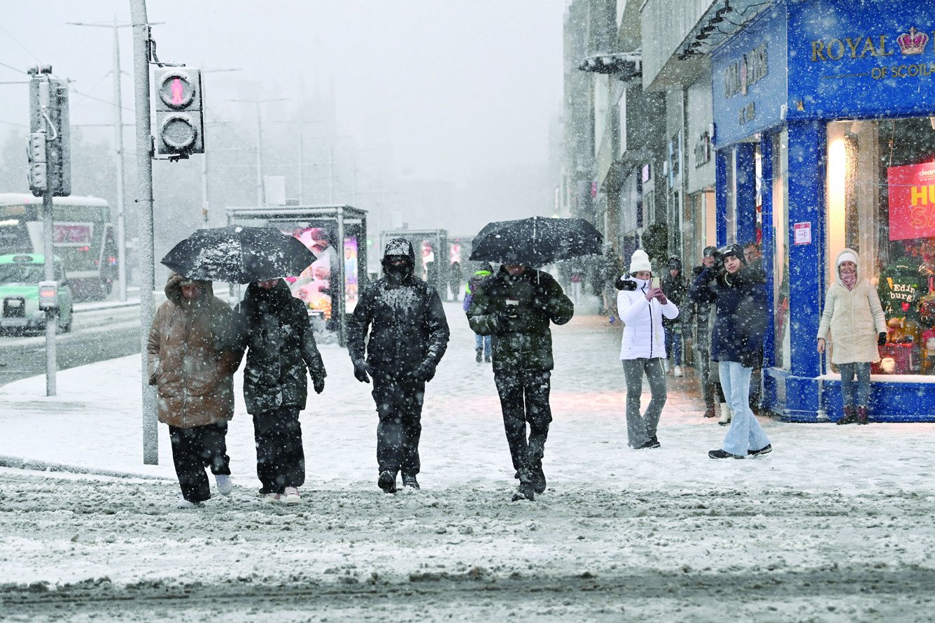 people walk amidst snowfall during storm bert along princes street in edinburgh photo reuters