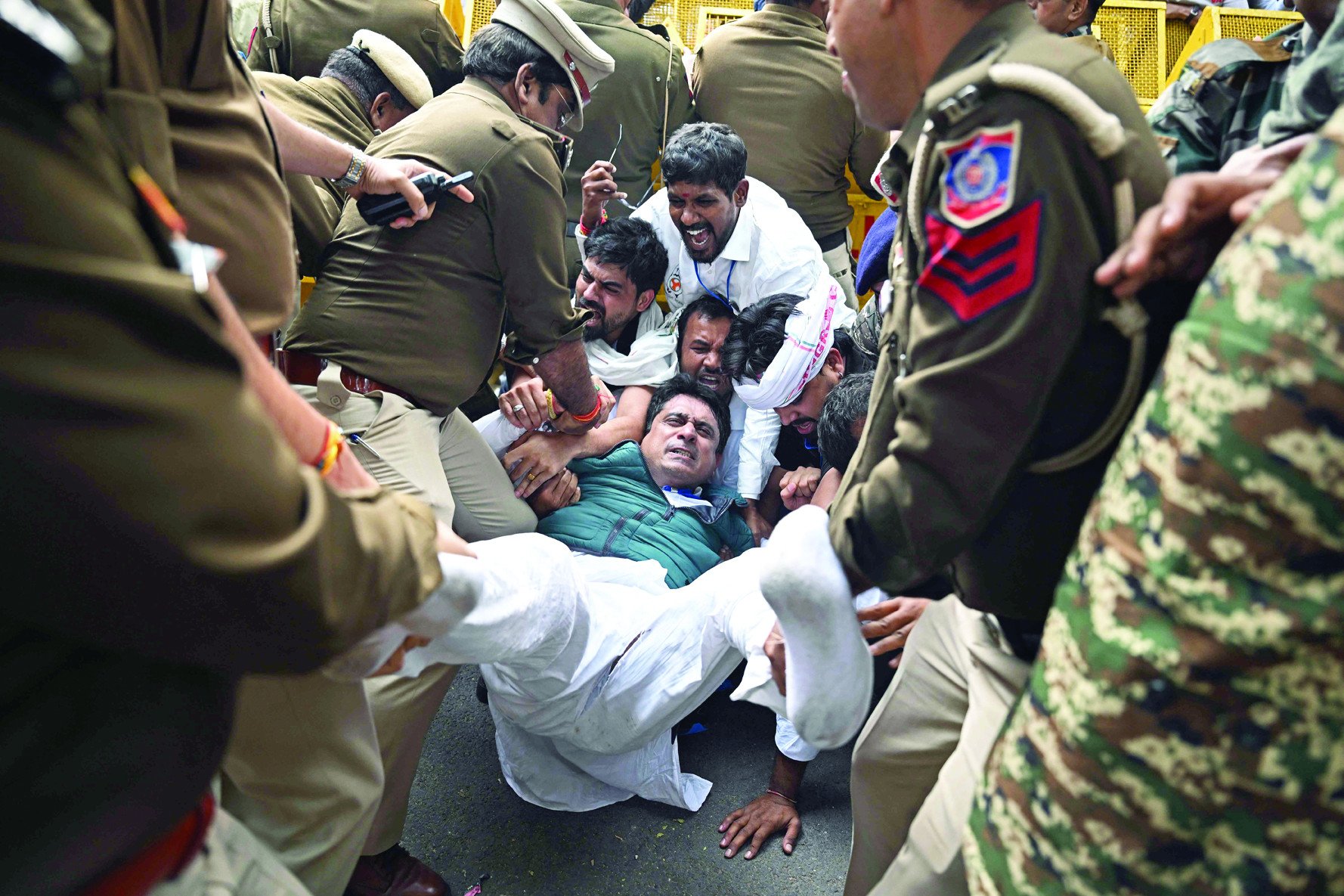 police personnel detain members of the indian youth congress during a protest against indian industrialist gautam adani in new delhi photo afp