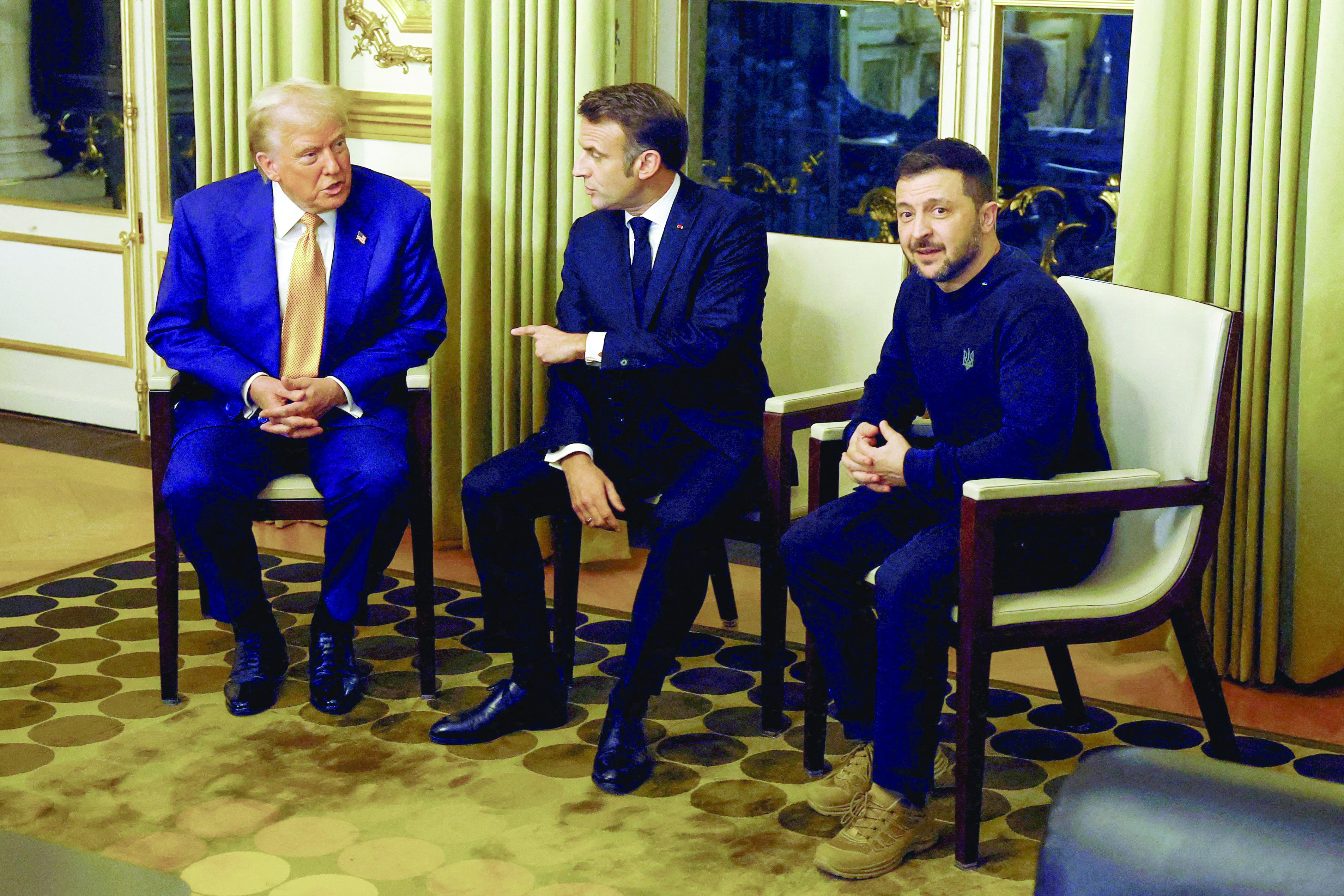 france s president emmanuel macron us president elect donald trump and ukraine s president volodymyr zelensky wait to pose before a meeting at the elysee presidential palace in paris photo afp