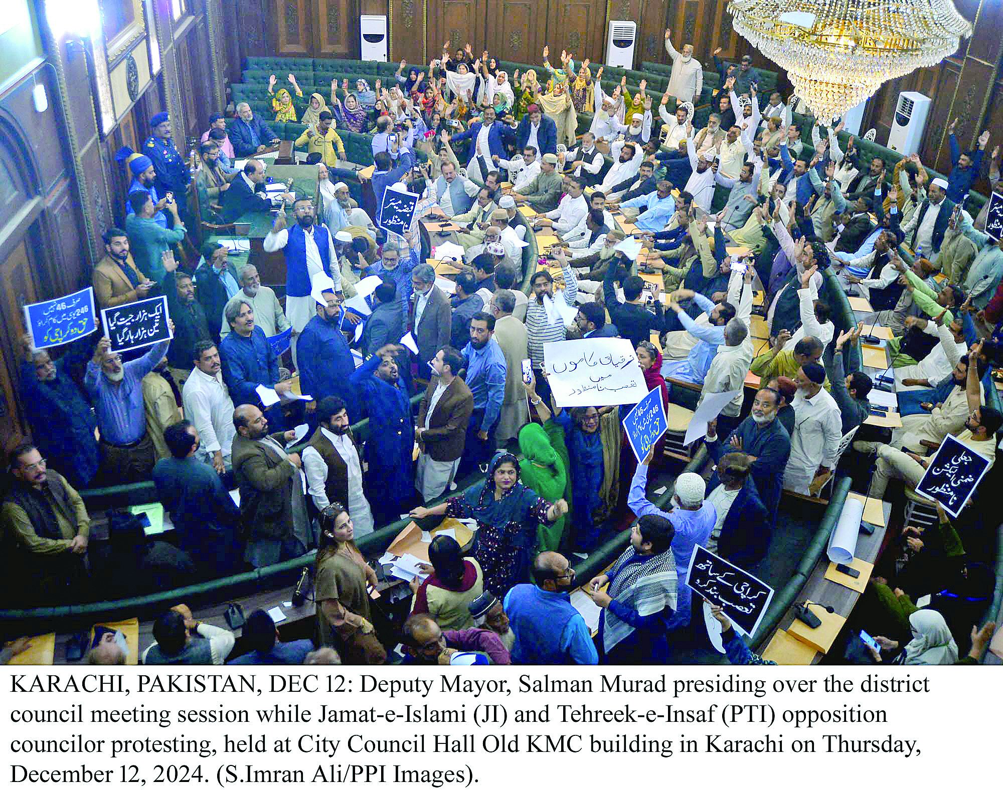 opposition members of the karachi metropolitan corporation city council stage protest during the council s meeting at the city hall on thursday photo express