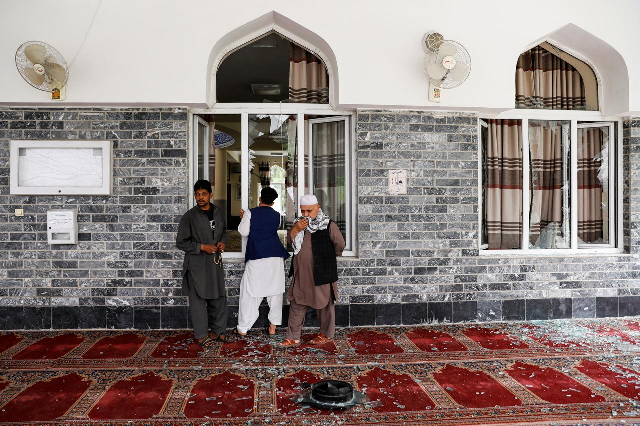 men inspect the site of a blast inside a mosque in kabul afghanistan june 12 photo reuters