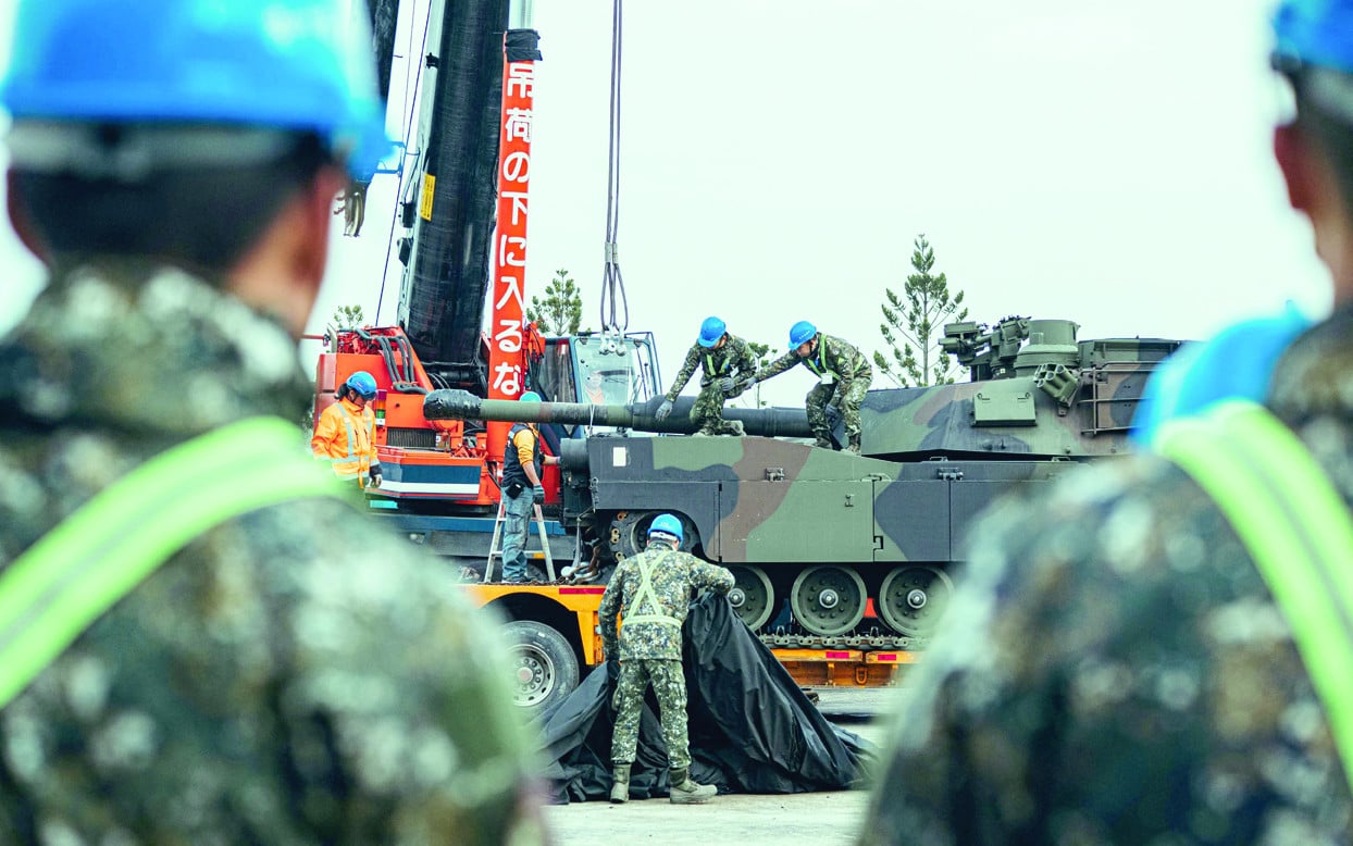 soldiers secure a us made m1a2 abrams battle tank onto a trailer at an army training centre in hsinchu taiwan photo afp