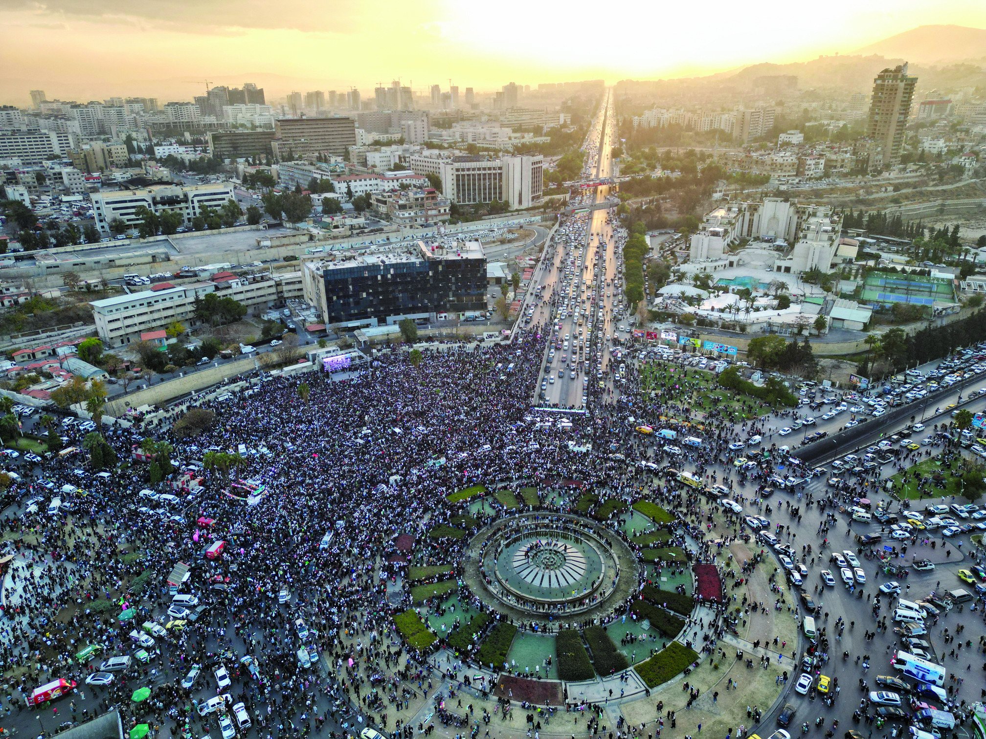 a drone view shows people gathering to celebrate after fighters of the ruling syrian body ousted bashar al assad at umayyad square in damascus photo reuters